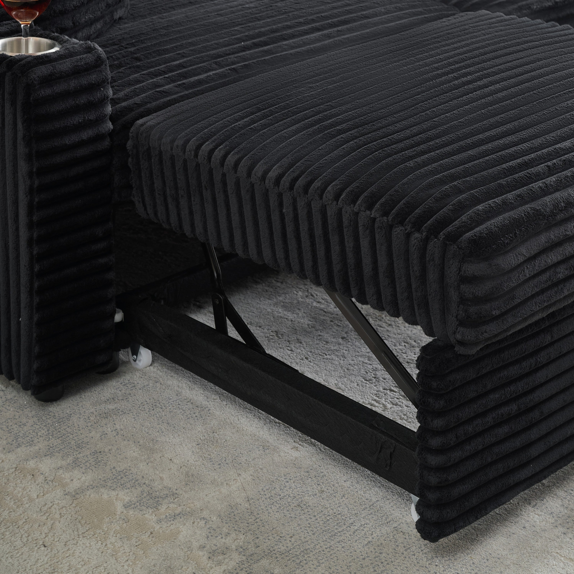 An 80-inch two-in-one pull-out, foldable and hidden chaise longue black corduroy sofa with cup holders and pillows, which is suitable for the living room.